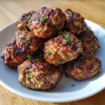 Air fryer basket filled with golden, crispy meatballs